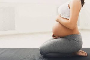 A picture of a pregnant woman doing yoga - Managing Pregnancy as a Teacher